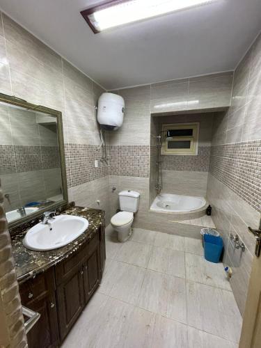 a bathroom with a sink and a toilet and a tub at Private Bella Rum Villa with Garden in Marsa Matruh