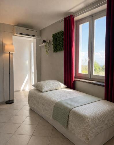 a bedroom with a bed and a window at Pino Center in Pino Torinese