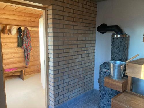 a room with a brick wall next to a door at Kenu Saunamaja in Haapsalu