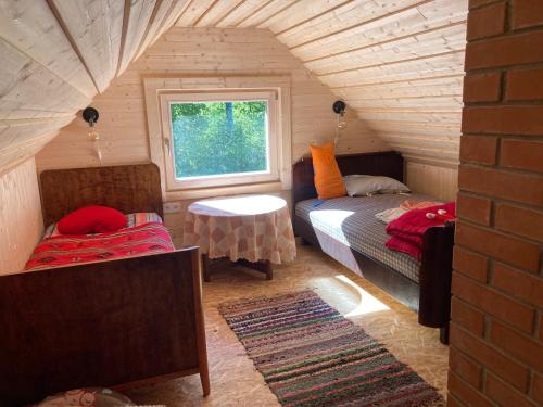 a small room with a bed and a window at Kenu Saunamaja in Haapsalu