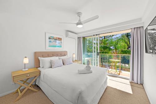 a bedroom with a bed and a large window at Pacific Regis Beachfront Holiday Apartments in Gold Coast