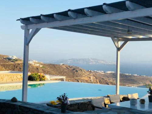 a swimming pool with a view of the ocean at Luxury Villa Dorothea Mykonos in Fanari