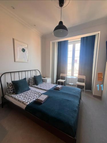 a bedroom with a large bed with a blue blanket at Apartments Monaco in Monte Carlo