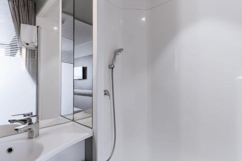 a bathroom with a shower and a sink at Ibis Budget Le Havre Les Docks in Le Havre