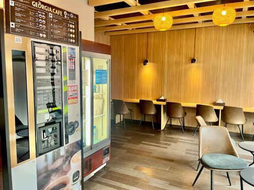 a waiting room with a row of tables and chairs at Yoroi Asakusa Hotel in Tokyo