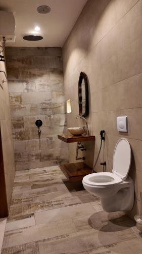 a bathroom with a toilet and a sink at Nook Villas in Bagamoyo