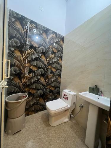 a bathroom with a toilet and a sink at Hotel Plain A Quiet Stay in Mubārikpur