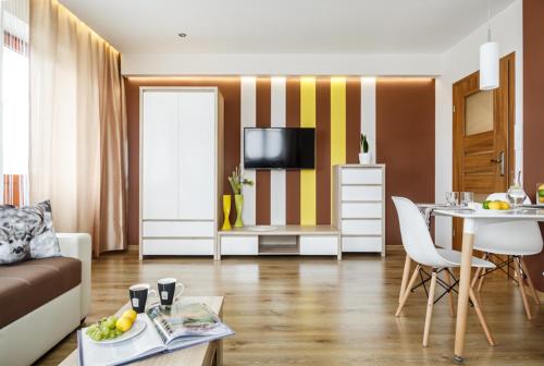 a living room with a couch and a table at U Lampy in Zakopane