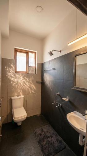 a bathroom with a toilet and a sink at Willostays Tamarind beach villa in Cherai Beach