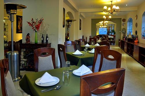 a dining room with tables and chairs in a restaurant at Casona Plaza Hotel Puno in Puno