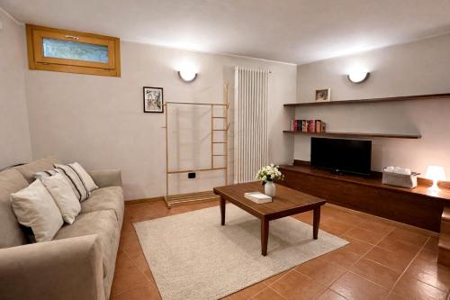 a living room with a couch and a coffee table at Appartamento LO SCOIATTOLO in Andalo