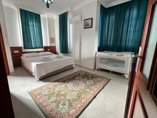 a bedroom with a bed and a rug at Dalyan Villa in Dalyan