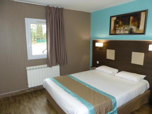a bedroom with a large bed with a window at Hotel ARBOR - Les Hunaudieres - Le Mans Sud - Mulsanne in Mulsanne