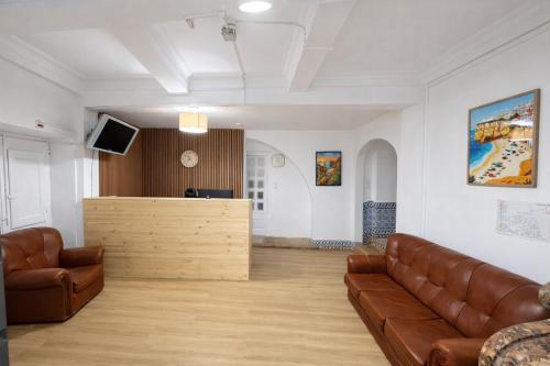 a living room with a couch and a counter at Relax Guesthouse & Hostel Lagos Central in Lagos