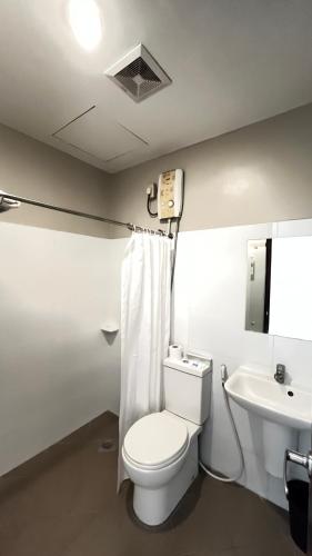 a bathroom with a toilet and a sink at Hotel 801 in Cagayan de Oro