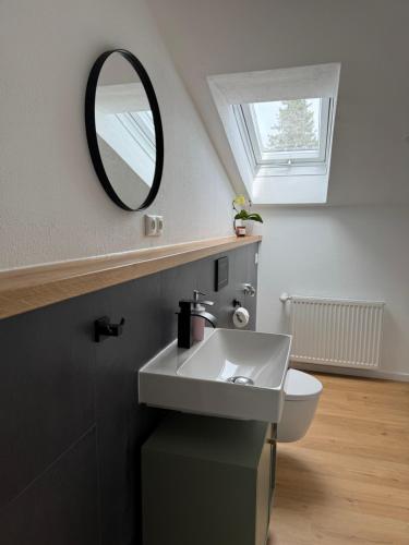 a bathroom with a sink and a mirror at Ferienwohnung Mayr in Füssen