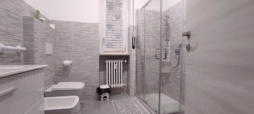 a bathroom with a shower and a toilet and a sink at Alloggio Tobia in Biella
