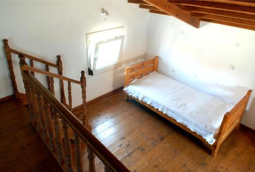 a bed in a room with a staircase with a window at Sigrion Villas in Sígrion