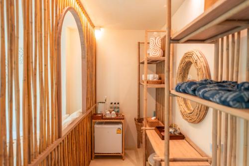 a room with two bunk beds and a mirror at La Lanna in Ban Pok Nai