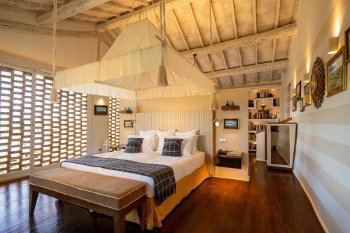 a bedroom with a large bed and a large window at L'Olmo in Monticchiello