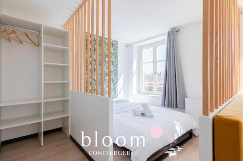 a bedroom with a bed and a window at Le Soleil du Marché central in Nancy