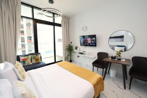 a bedroom with a bed and a mirror and a desk at Central Stay Studio Apartment near Cleveland and Abu Dhabi Mall in Abu Dhabi