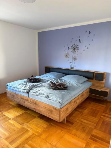 a bedroom with a bed with two shoes on it at Ferienhaus Mila in Löbau