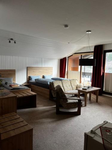 a large bedroom with a bed and a couch at Linnenkerlstube in Willingen