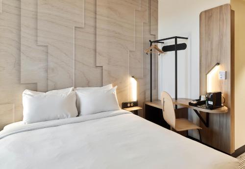 a hotel room with a bed and a desk at B&B HOTEL Rennes Liffré in Liffré