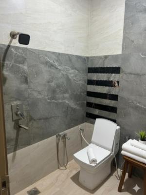 a bathroom with a toilet and a shower at Shri Radha Kripa Dham in Rādha Kund