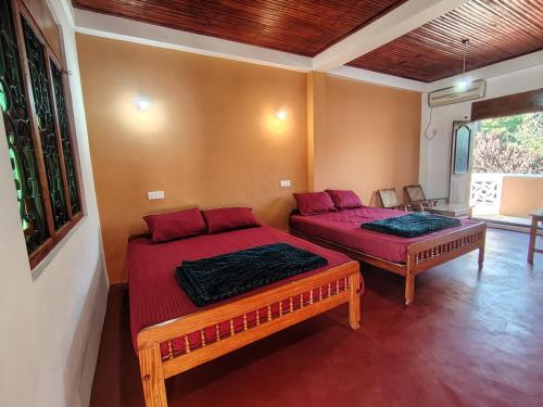 a room with two beds in a room at The zen inn in Nikawatawana