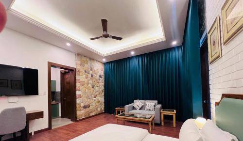a living room with a couch and a ceiling fan at Mastiff Citadel RC in Chūharpur