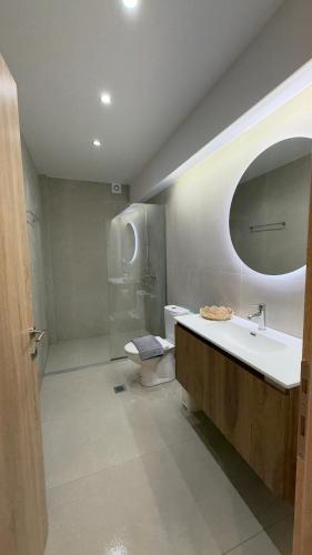 a bathroom with a sink and a shower and a toilet at Sweet Nest in Paralia Katerinis