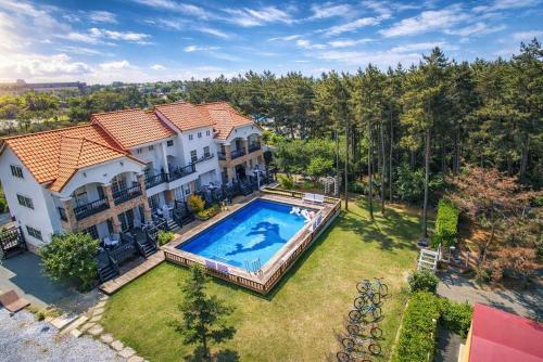 an overhead view of a house with a swimming pool at Taean Red Balloon Pension in Taean