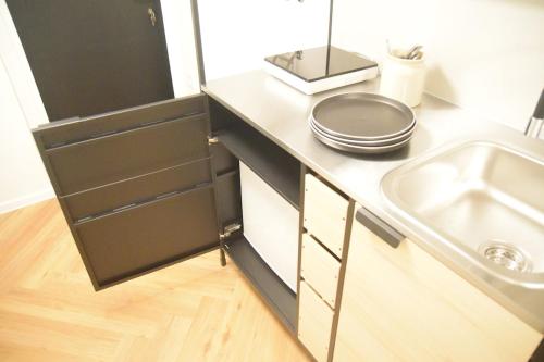 a kitchen with a sink and a counter top at Blossoming Hidden Nest with Garden in Ljubljana