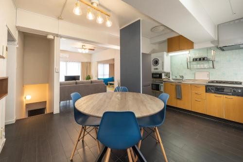 a kitchen and dining room with a table and chairs at AS Residence Komagome in Tokyo