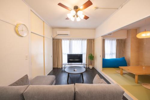a living room with a couch and a table at AS Residence Komagome in Tokyo