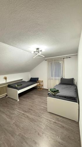 a bedroom with two beds and a ceiling fan at Monteurswohnung Mesum in Rheine