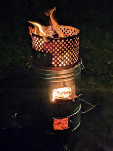 a fire in a pot sitting on the ground at Gubo 里山ヴィレッジ 白木 in Katsuura