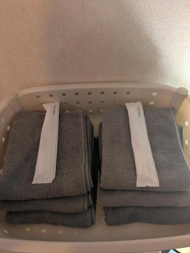 a bunch of towels in a laundry basket at Gubo 里山ヴィレッジ 白木 in Katsuura