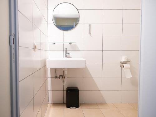 a bathroom with a sink and a mirror at Hotel Bentley in Brussels