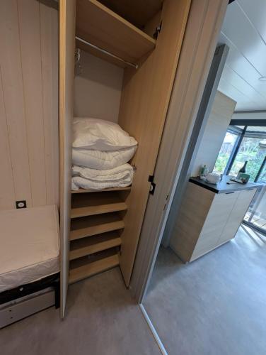 a small room with a bed and a closet at Luxury Cottage Sauna&Pool at CapDAgde in Agde