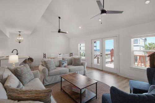 a living room with a couch and a table at Spacious 3BR Beach Retreat Sleeps 10 Family Ready in Port Saint Joe