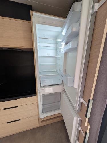an empty refrigerator with its door open in a room at Luxury Cottage Sauna&Pool at CapDAgde in Agde