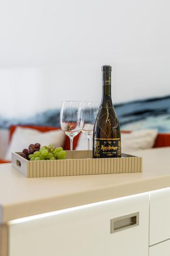 a bottle of wine and wine glasses on a table at PREMIUM Apartments Old Town in Košice
