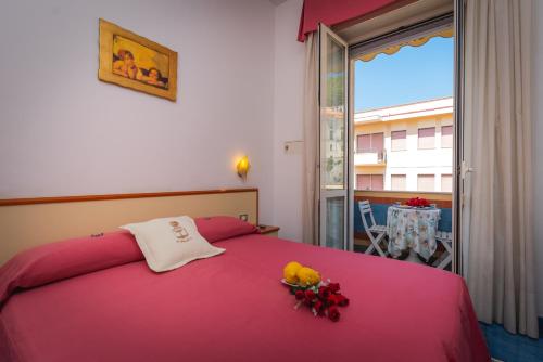a bedroom with a pink bed with flowers on it at Meublè Casa Mannini Rooms in Maiori