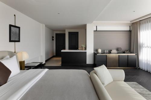 a living room with a bed and a kitchen at Arcadia Small courtyard in Dali Shuanglang
