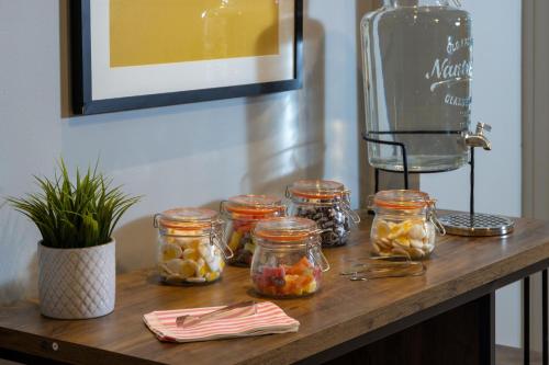 a table with jars of fruit and a blender at Cambridge Bar Hill Hotel, BW Signature Collection in Cambridge