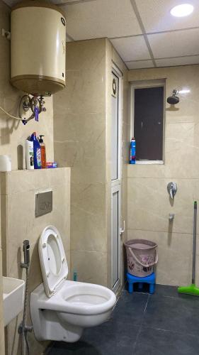 a bathroom with a toilet and a sink at The Horizon House in Zirakpur
