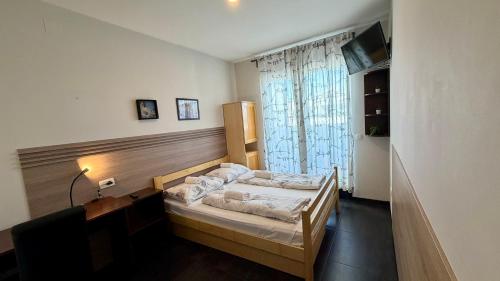 a bedroom with a bed and a window at Hostel Moving in Zagreb